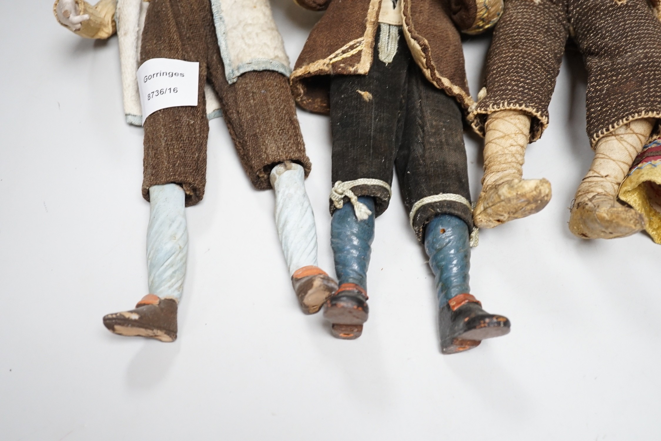 Four 18th/19th century Neapolitan painted wood or terracotta crèche figures, tallest 31.5cm and a 20th century miniature Bauernschrank